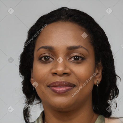 Joyful black young-adult female with long  black hair and brown eyes