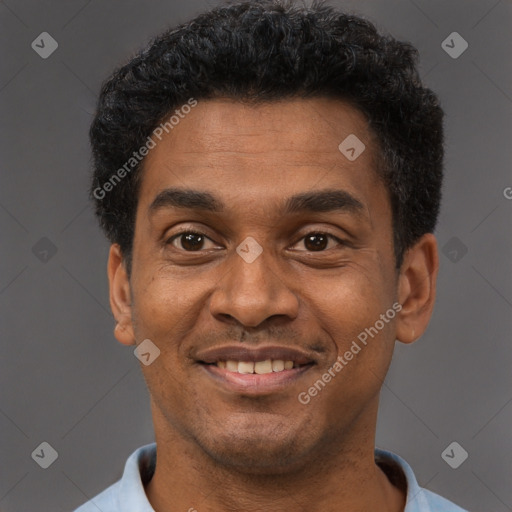 Joyful black adult male with short  black hair and brown eyes