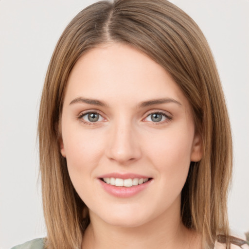 Joyful white young-adult female with medium  brown hair and green eyes