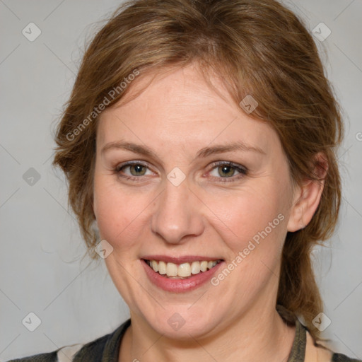 Joyful white adult female with medium  brown hair and blue eyes