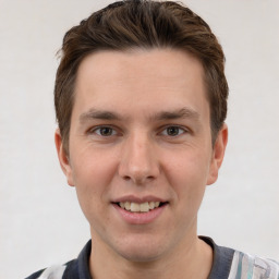 Joyful white young-adult male with short  brown hair and grey eyes