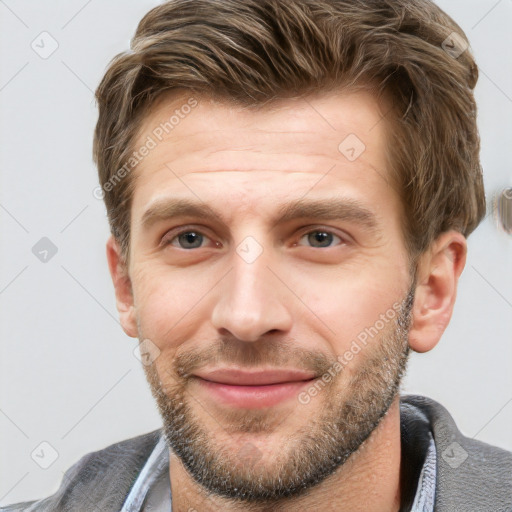 Joyful white young-adult male with short  brown hair and grey eyes