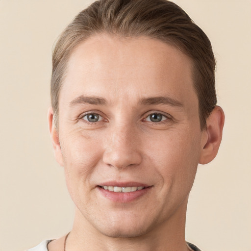 Joyful white young-adult male with short  brown hair and grey eyes