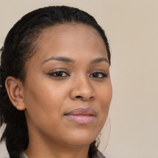 Joyful black young-adult female with medium  brown hair and brown eyes