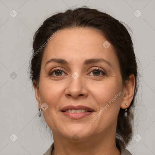 Joyful white adult female with medium  brown hair and grey eyes