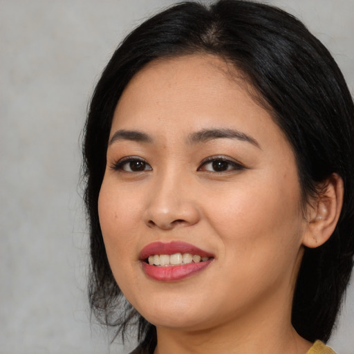 Joyful asian young-adult female with medium  black hair and brown eyes