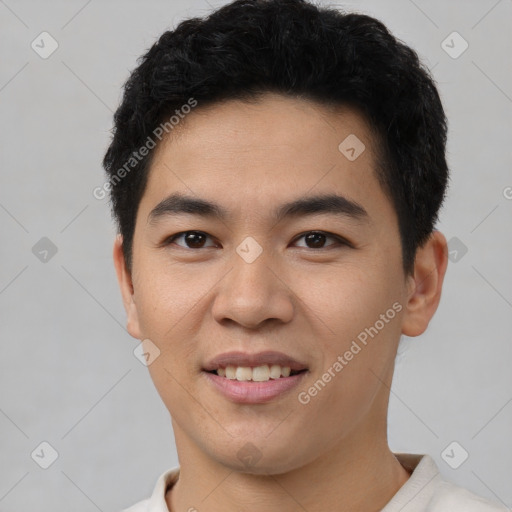 Joyful asian young-adult male with short  black hair and brown eyes