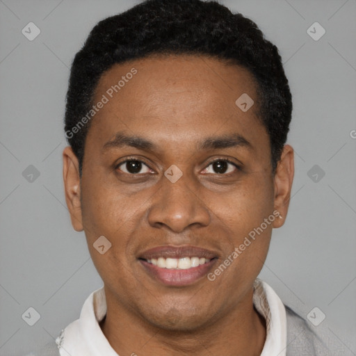 Joyful black young-adult male with short  black hair and brown eyes