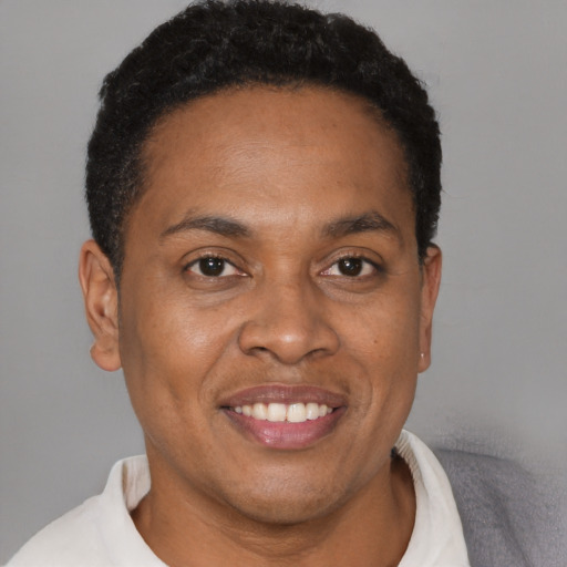 Joyful black adult male with short  brown hair and brown eyes