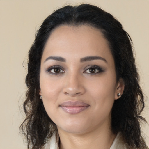 Joyful latino young-adult female with long  brown hair and brown eyes