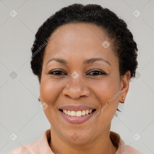 Joyful black adult female with short  brown hair and brown eyes