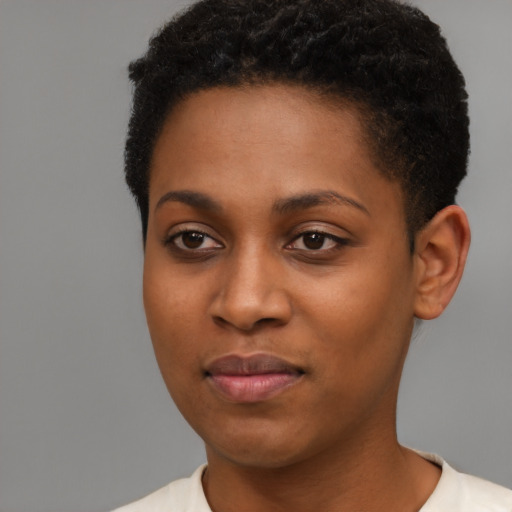 Joyful black young-adult female with short  black hair and brown eyes