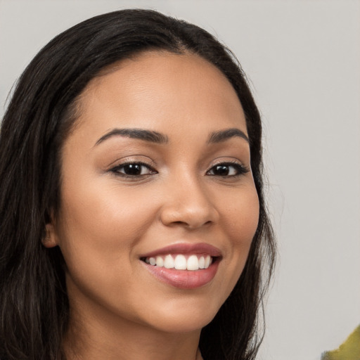 Joyful latino young-adult female with long  brown hair and brown eyes