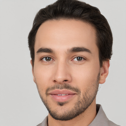 Joyful white young-adult male with short  black hair and brown eyes