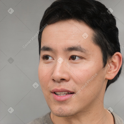 Joyful asian young-adult male with short  black hair and brown eyes