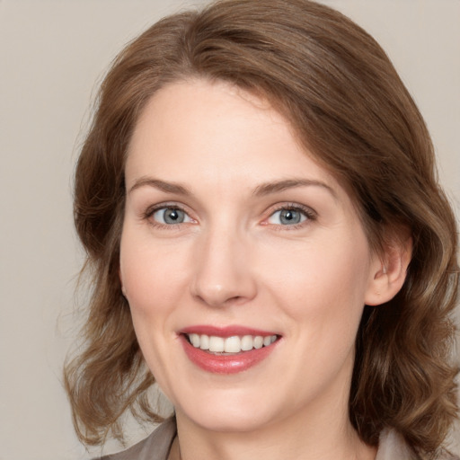 Joyful white young-adult female with medium  brown hair and green eyes