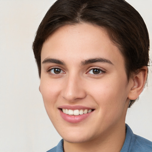 Joyful white young-adult female with medium  brown hair and brown eyes