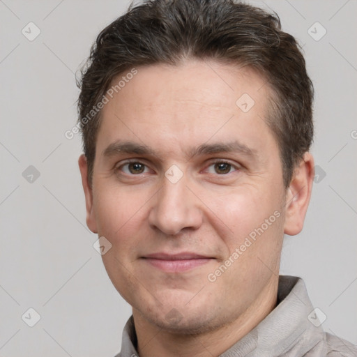 Joyful white adult male with short  brown hair and brown eyes