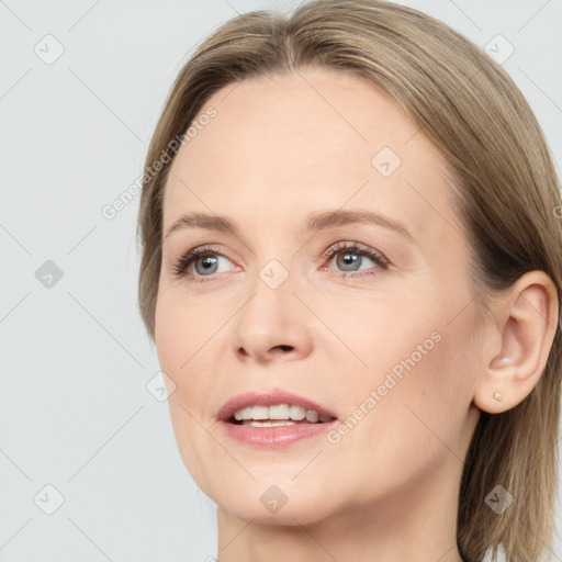 Joyful white young-adult female with long  brown hair and grey eyes