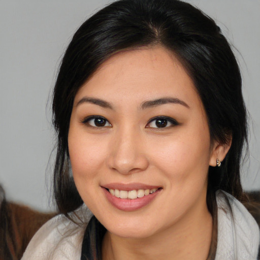 Joyful asian young-adult female with medium  brown hair and brown eyes