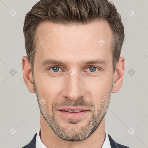 Joyful white adult male with short  brown hair and grey eyes