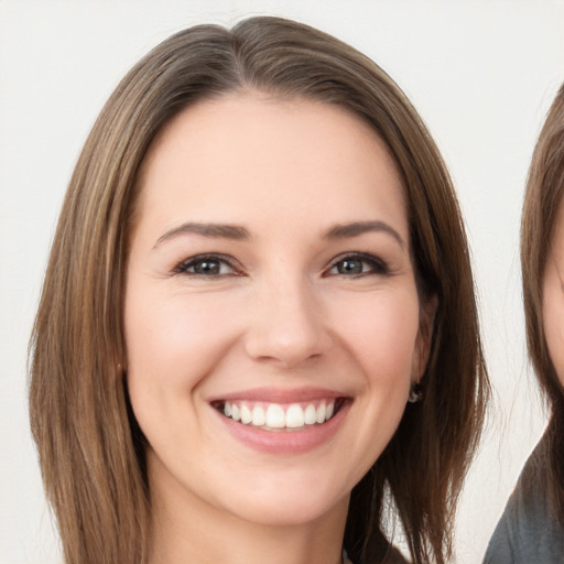 Joyful white young-adult female with long  brown hair and brown eyes