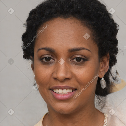 Joyful black young-adult female with long  black hair and brown eyes