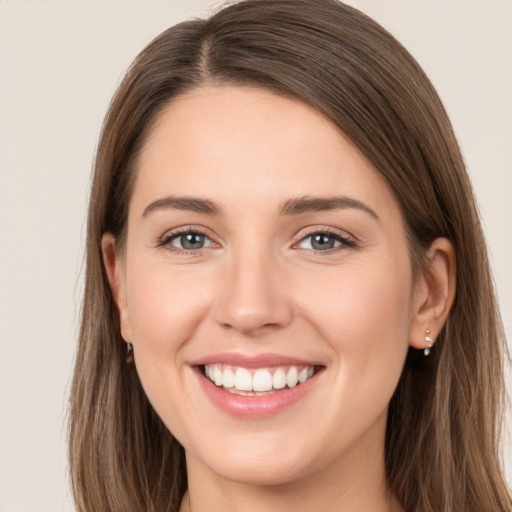 Joyful white young-adult female with long  brown hair and grey eyes