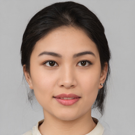 Joyful asian young-adult female with medium  black hair and brown eyes