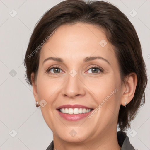 Joyful white adult female with medium  brown hair and grey eyes