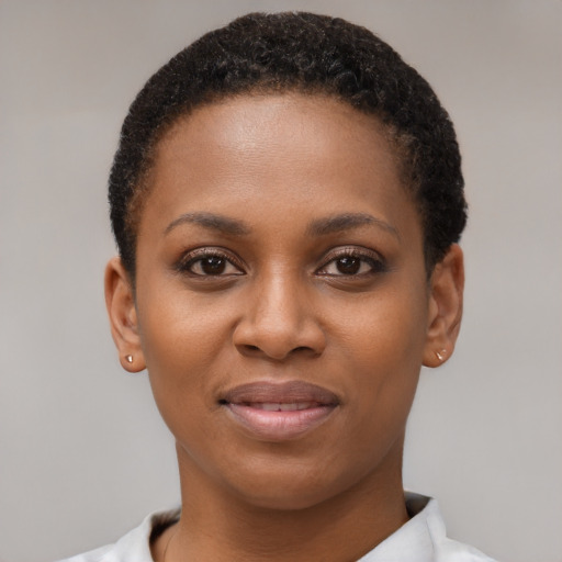 Joyful black young-adult female with short  brown hair and brown eyes