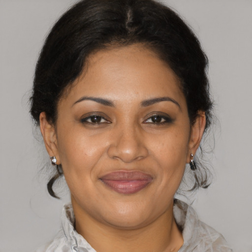 Joyful latino adult female with medium  brown hair and brown eyes
