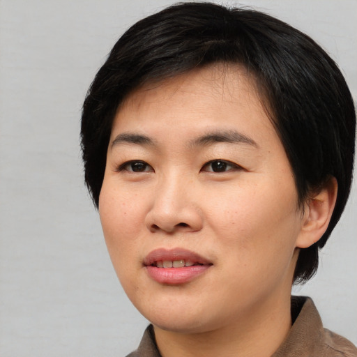 Joyful asian young-adult female with medium  black hair and brown eyes