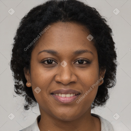 Joyful black young-adult female with long  brown hair and brown eyes