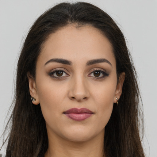 Joyful white young-adult female with long  brown hair and brown eyes