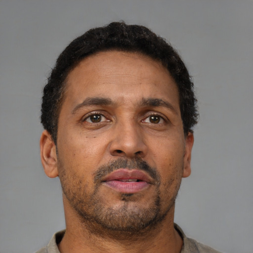 Neutral latino adult male with short  brown hair and brown eyes