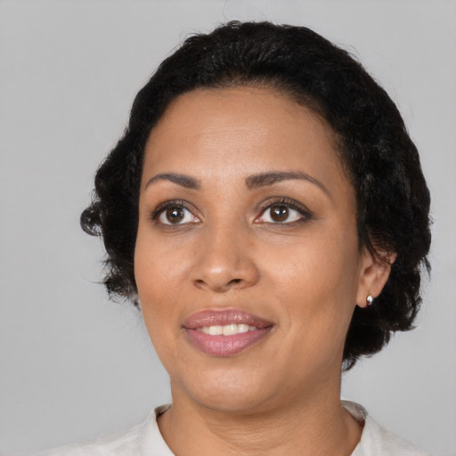 Joyful black young-adult female with medium  black hair and brown eyes