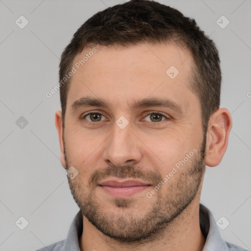 Joyful white young-adult male with short  brown hair and brown eyes