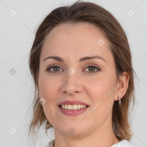 Joyful white young-adult female with medium  brown hair and grey eyes