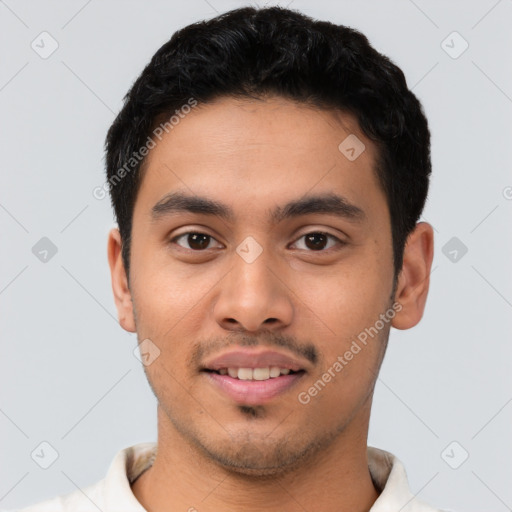 Joyful latino young-adult male with short  black hair and brown eyes