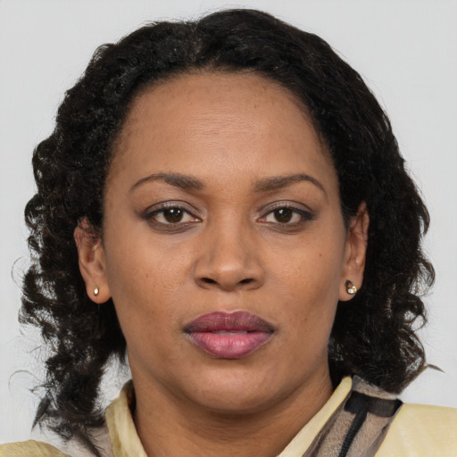 Neutral black adult female with long  brown hair and brown eyes