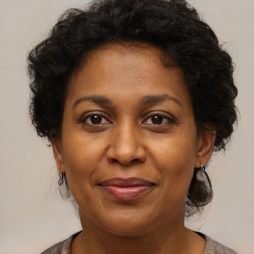 Joyful black adult female with medium  brown hair and brown eyes