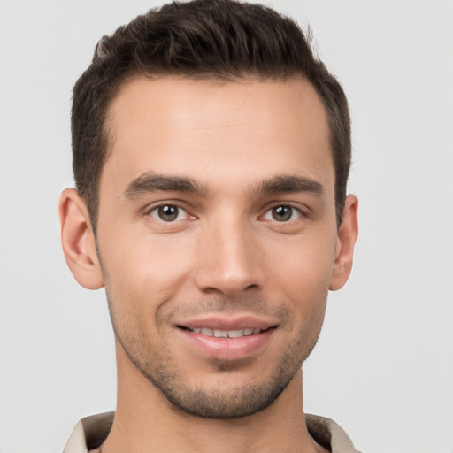 Joyful white young-adult male with short  brown hair and brown eyes