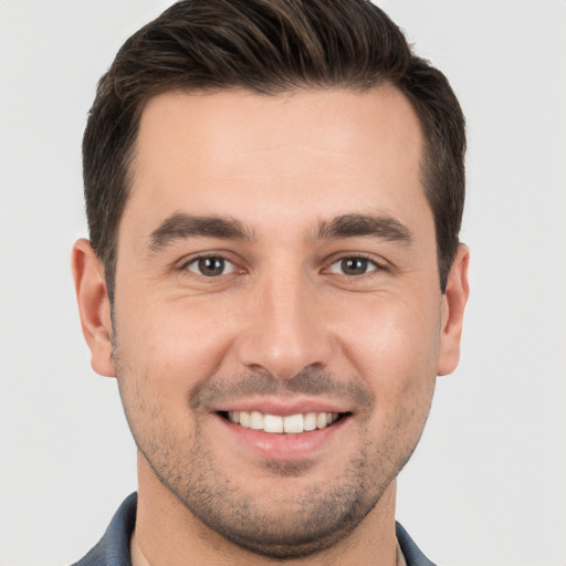 Joyful white young-adult male with short  brown hair and brown eyes