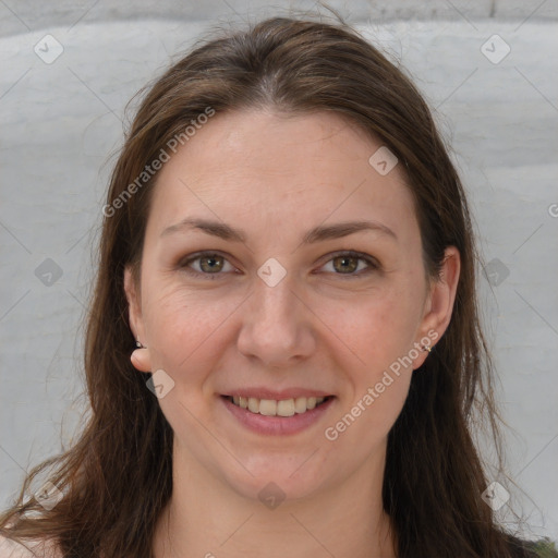 Joyful white adult female with long  brown hair and grey eyes