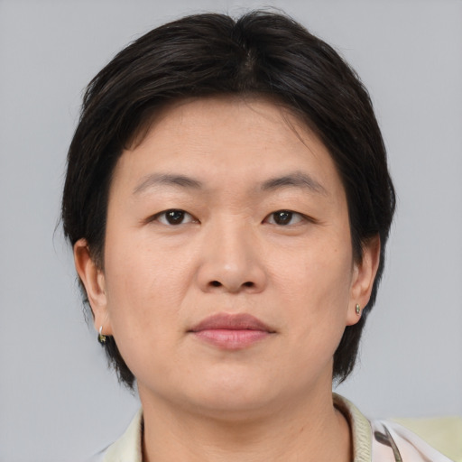 Neutral asian adult female with medium  brown hair and brown eyes