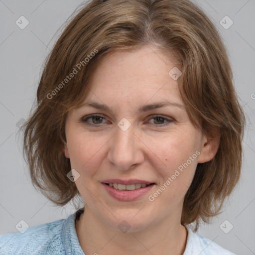 Joyful white adult female with medium  brown hair and blue eyes