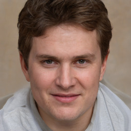 Joyful white adult male with short  brown hair and grey eyes