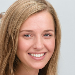 Joyful white young-adult female with long  brown hair and blue eyes