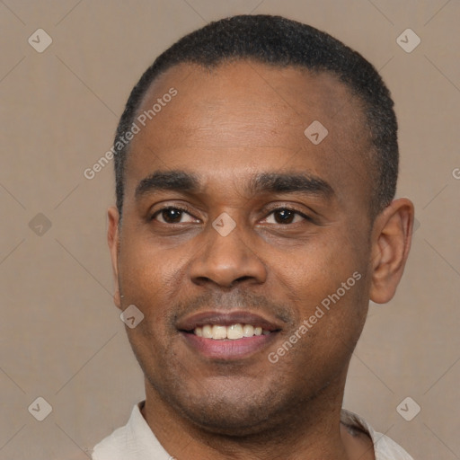 Joyful black young-adult male with short  black hair and brown eyes